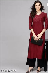 Maroon rayon kurta with black palazzo set, embroidered net design, three-quarter sleeves. Soft, breathable fabric for women's casual or festive wear