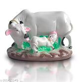 Resin cow with calf idol, symbolizing prosperity & love. Handmade decorative figurine, ideal for home, office, or gifting. Size: 19.5 cm (L) x 12 cm (H) x 12 cm (B). May slightly vary in color due to lighting or monitor settings. Origin: India