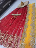 Red embroidered organza Lehenga Choli & dupatta set, unstitched (Lehenga waist size: 41 in, Lehenga length size: 42 in, Dupatta length size: 2.4 in). Indian mirror work on silk, organza, and net fabrics. In the box: 1 un-stitched red lehenga, 3 mtr dupatta (yellow), 1 gold blouse piece, and an embellished belt. Origin: India