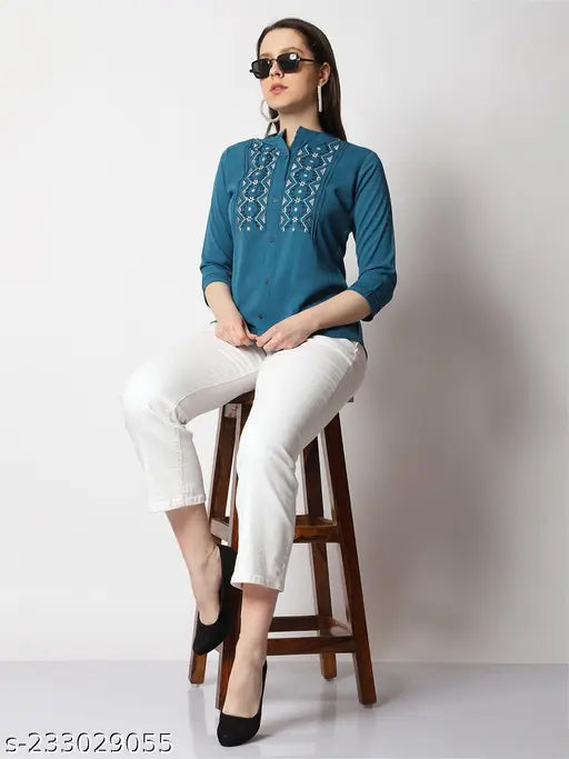 Green polyester embroidered top with three-quarter sleeves, unique design by experienced Indian fashion designer