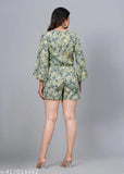 Green rayon short jumpsuit with three-quarter sleeves, printed net pattern. High-quality fabric, suitable for various sizes M-XXL. Indian-made fashion jumpsuit on display