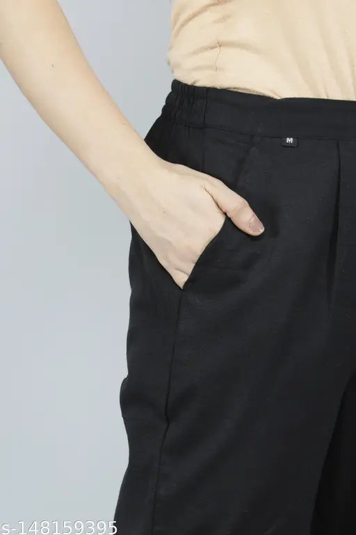 Cotton women's black pant: Solid black cotton blend pants with pockets on both sides, ankle length bottom fold, pleats detailing, and elasticated back. Perfect for any occasion, made in India