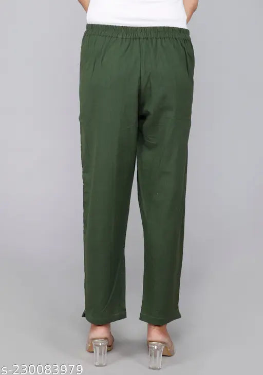 Green cotton solid trouser pants by Rakshita Fashions, comfortable with pleats, pockets, and elasticated back - versatile for casual wear or office use