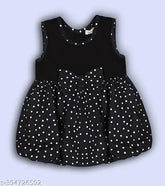 Black polka dotted cotton blend balloon dress for children, featuring charming bow detail and midi length with round neck design, ideal for various occasions. Made in India