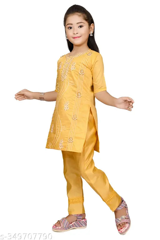 Yellow Chanderi cotton embroidered kurta set for girls, three-quarter sleeves, straight top with pyjama bottoms, popular Indian fashion on model