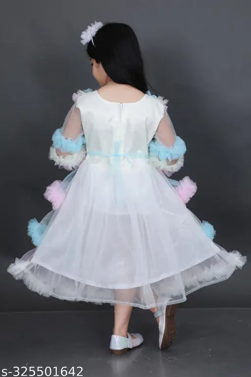Embroidered net, long-sleeved fancy frock for kid girls. Indian handcrafted kid's dress on mannequin