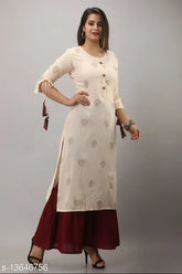 Printed rayon kurta with tiered sharara, golden motifs and three-quarter sleeves - Indian ethnic wear
