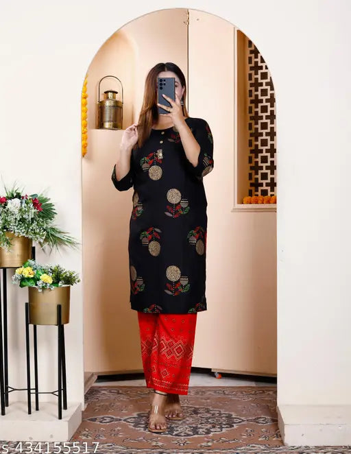Rayon printed kurta set with palazzos, three-quarter sleeves and round neck. Trendy women's fashion for comfortable everyday wear, designed in India