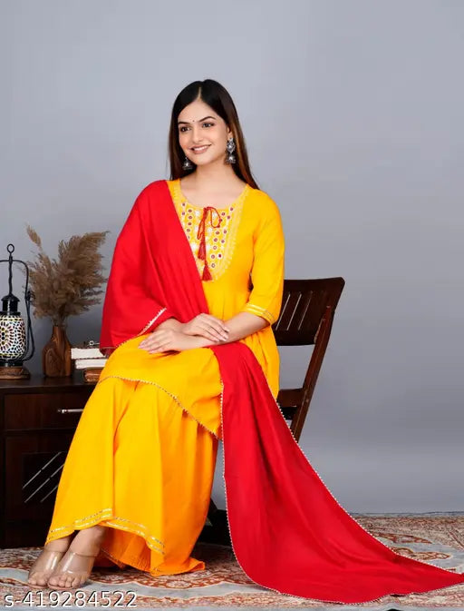 Rayon women's yellow and red Kurta set with Sharara and dupatta, featuring three-quarter sleeves and embroidered embellishments. Hand wash only, suitable for various occasions