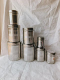 Silver stainless steel vertical canisters set of 8, featuring sizes 350ML, 500ML, 700ML, 900ML, 1.25Ltr, 1.6Ltr, 2.2Ltr, 2.9Ltr for food storage