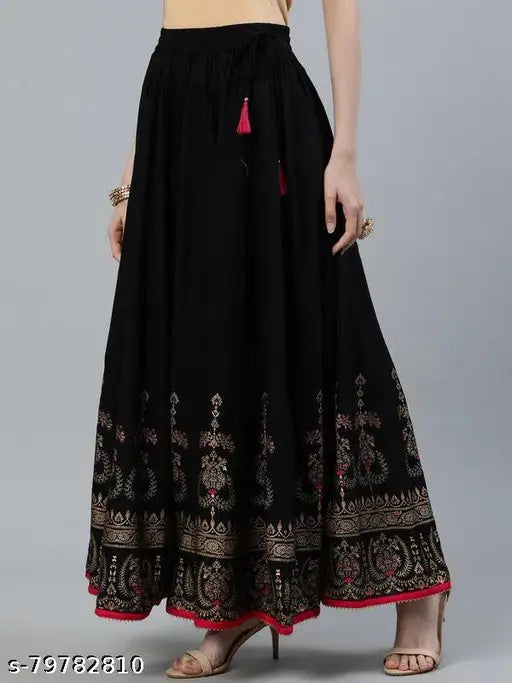 Rayon printed net skirt combo: One black and one green Jaipuri gold-printed long skirts for women, suitable for weddings and parties. Free size up to waist 36 inches, length 40 inches. Made in India