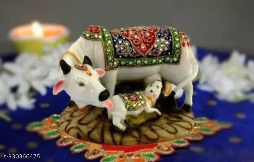 Marble Kamdhenu Cow and Calf Idol - Detailed, handcrafted statue featuring Mother Cow and her Calf adorned with red and green clothes and decorative stones, perfect for home décor or temple spaces