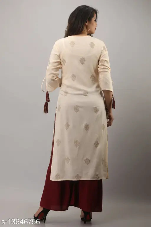 Rayon printed tassel kurta with tiered sharara, gold detailing on Indian women's fashion