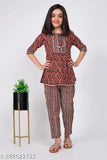 Embroidered cotton girls kurta and pant set in printed net, three-quarter sleeves, sizes range from 8-9 years to 13-14 years. Indian traditional clothing for girls on display