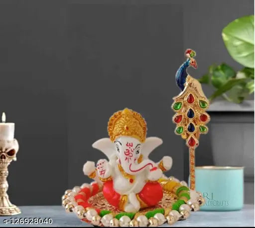 White terracotta Ganesh idol with gold-plated plate and free Tilak stick, for car dashboard decoration. Dimensions: 10cm x 10cm x 10cm (LxWxH). Indian God Ganesha combo