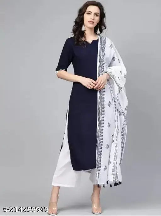 Navy blue and white women's rayon kurta, palazzo, and dupatta set with V-neck, short sleeves, side slits, elastic waistband, and one pocket. Solid navy blue kurta, solid white palazzos, and printed dupatta in tessel design. Pure cotton dupatta. Machine washable. India origin