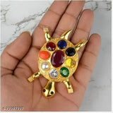 Gold-polished brass Feng Shui Kachua Tortoise figurine with Navratna gemstones, for good luck office decor. Each gemstone represents a planet: Ruby, Pearl, Red Coral, Emerald, Yellow Sapphire, Diamond, Blue Sapphire, Hessonite, Cat's Eye. Handmade, unique piece. Place in home back area or entrance for energy stabilization, near water features or north sector for career. Made in India