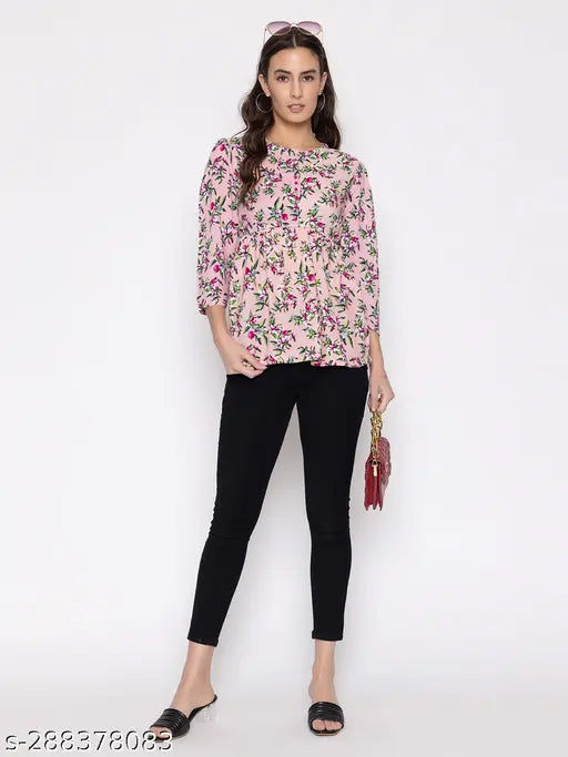 Printed cotton blend women's top with three-quarter sleeves, vibrant pattern on soft fabric, available in sizes S, M, L, XL