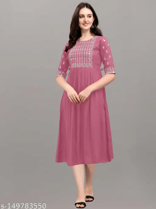 Embroidered rayon kurta in classic colors, three-quarter sleeves. Relaxed fit for casual or festive wear. Made in India