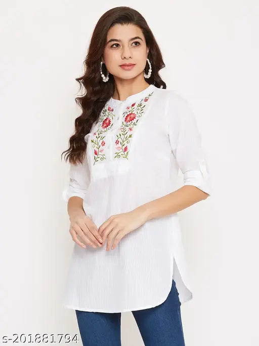 Floral embroidered rayon women's tunic with short sleeves, mandarin collar, and curved hem. White, cotton fabric, perfect for office or college wear. Made in India