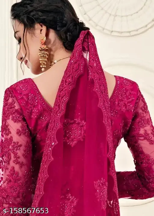 Embroidered net lehenga set with choli and dupatta, intricate Indian bridal wear on display