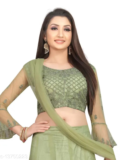 Green embroidered nylon net Vaksha Pista flared lehenga with unstitched blouse on mannequin