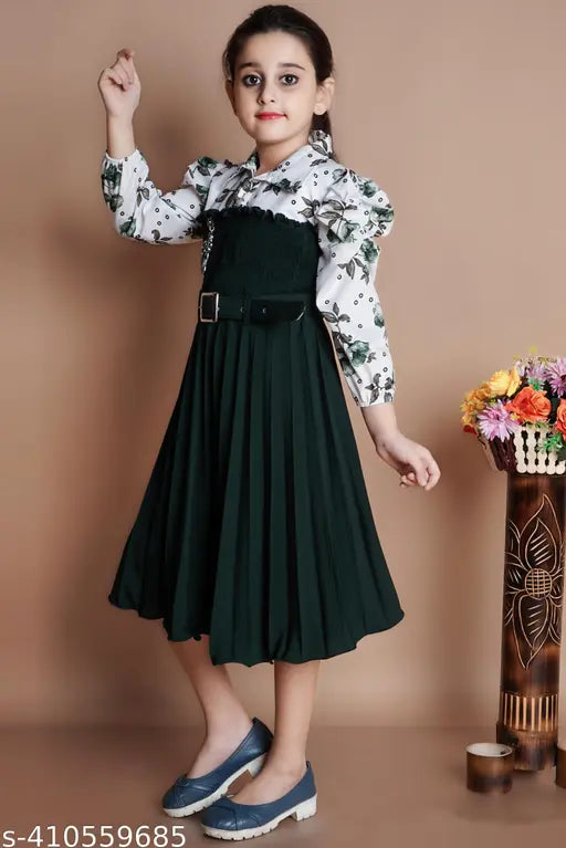 Green crepe frock with belt for girls' parties, features long sleeves and a printed net pattern. Available in sizes: 5-6Y, 6-7Y, 7-8Y, 8-9Y, 9-10Y, 10-11Y. Made in India