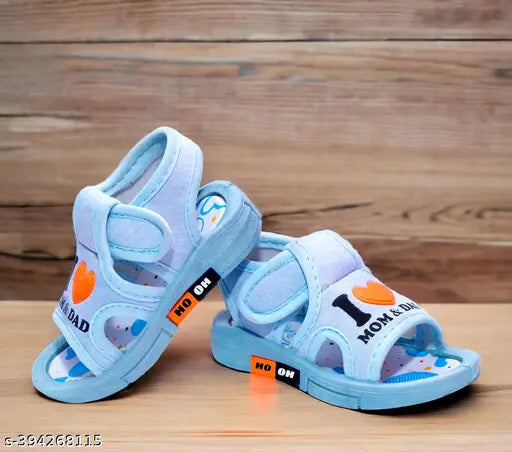 Blue canvas and rubber Whistle music sound sandals for little kids. Fun printed net pattern, comfortable and supportive sole." (96 characters)