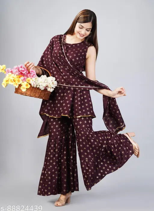 Hand-block printed rayon kurti set with sharara and dupatta, featuring gold embellishments. Made in India, XS to L sizes available