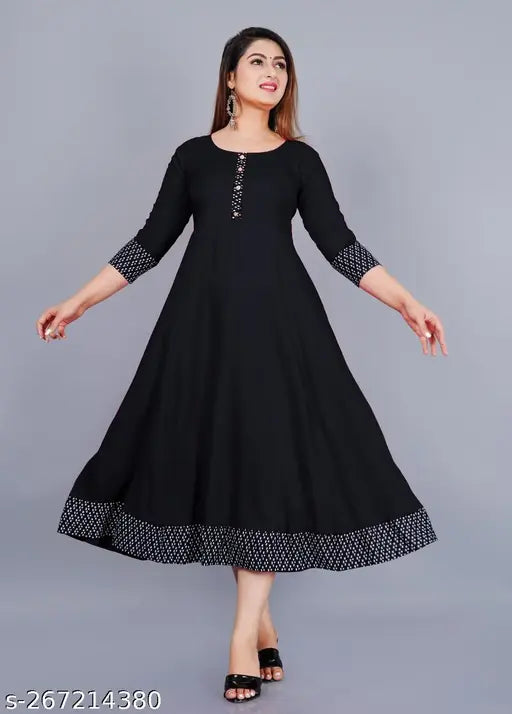 Stylish black rayon round pleated flared kurti with three-quarter sleeves, suitable for casual and formal occasions. Size range: XS-XXXL. Hand wash or machine wash; made in India
