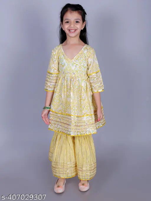 Yellow cotton paisley print Anarkali/Flared Kurta & Sharara Set for girls, featuring intricate embellishments and a flared silhouette. Ideal for special occasions or festive celebrations, available in sizes 2-3 Years to 9-10 Years (India origin)