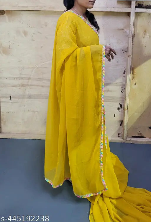 Yellow Georgette saree with embroidered blouse, embellished Indian fashion for women on display