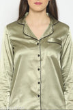 Green satin pyjama set for women, solid design with long sleeves and matching shirt on hangar