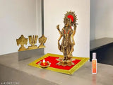 Red velvet carpet Chaturbahu Vishnu figurine, golden diya oil lamp, and moti mala on Pooja Aasan deity ornament for religious worship. Premium aluminum handicraft