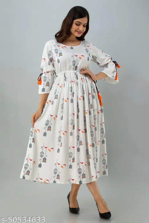 White bird cage print rayon flared long kurta, three-quarter sleeves, tassels detailing. Indian fashion item with quirky bird and cage design, suitable for ethnic wear. Lightweight and airy rayon fabric