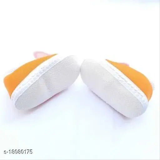 Stylish PU orange baby booties with velcro fastening and embellished net pattern, perfect for protecting little feet during all seasons