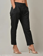 Black cotton solid trouser pants by Rakshita Fashions, comfortable fit with pleats detailing, ankle length, side pockets, elasticated back, suitable for casual or office wear