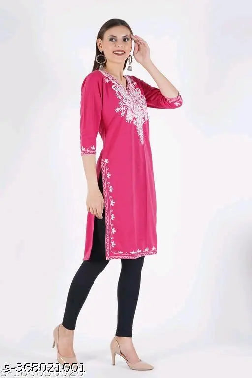 Pink embroidered wool A-line kurta for women. Cozy wool fleece, intricate Aari embroidery, calf-length with three-quarter sleeves. Winterwear for parties and casual occasions." (123 characters)