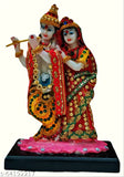 Multicolor poly resin Lord Radha Krishna Murti statue for puja home decor, intricately detailed with fancy stones on lotus platform. Indian origin." (108 characters)