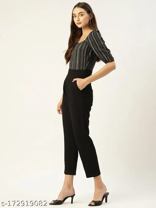 Black & White striped crepe jumpsuit by Magnetic Designs, short sleeves and solid net pattern. Accessible fashion for women, available in sizes S, L, XL. Model shown wears size L. Made in India