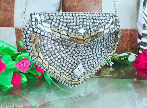 Handmade silver heart sheep style party clutch with suede interior and embroidered net design, ideal for accessories storage at events