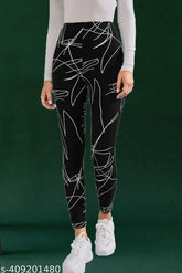 Black printed net lycra jeggings for women's sports wear, comfortable elastic waist and full bottom length. Available in sizes 26, 28, 30, 32, 34, 36 (waist 26-36 inches, hip 30-40 inches, length 40-43 inches). Made in India