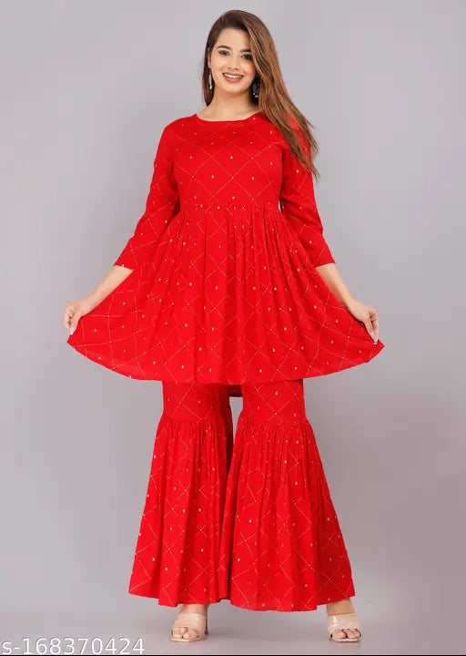 Red printed rayon Kurta and Sharara set with 3/4 sleeves, boat neck, and gold embellishments - Indian fashion wear