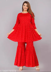 Red printed rayon Kurta and Sharara set with 3/4 sleeves, boat neck, and gold embellishments - Indian fashion wear