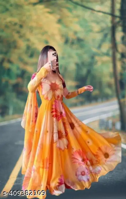 Orange Georgette printed gown with long sleeves and round neckline, suitable for women's formal events. Indian made net dress with attached dupatta in size S-XXXL