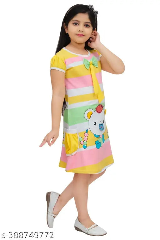 Yellow cotton blend knee length bow tie-ups dress for kids and girls, vibrant color on playful model