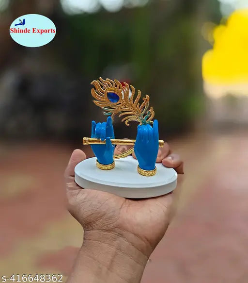 Blue Krishna Hand with Flute Figurine, small size for car dashboard decor or tabletop decor, made from durable material. Gift idea for religious occasions like Diwali, Janmashtami, or house warming ceremonies. Available in three colors: blue, gold, and maroon. Dimensions: 10.5x10.5x6cm, weight: approximately 180gms. Smooth and glossy texture. Origin: India