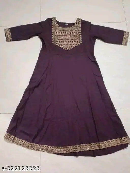 Maroon flared rayon kurti with intricate gold print, perfect for casual or festive occasions