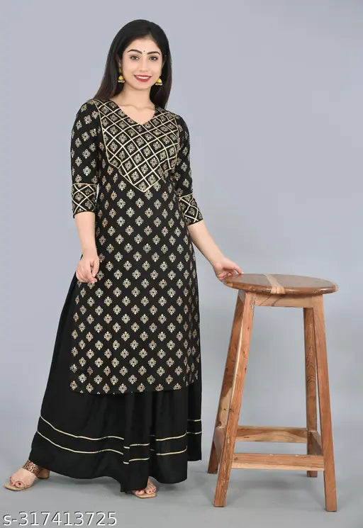 Black rayon straight kurta with skirt set featuring gold print gota lace, 3/4th sleeves, knee-length, ideal for casual and evening wear. Authentic Indian fashion from Liyara brand