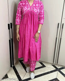 Pink cotton kurti set with pants by G Enterprises, featuring three-quarter sleeves and printed pattern on display rack